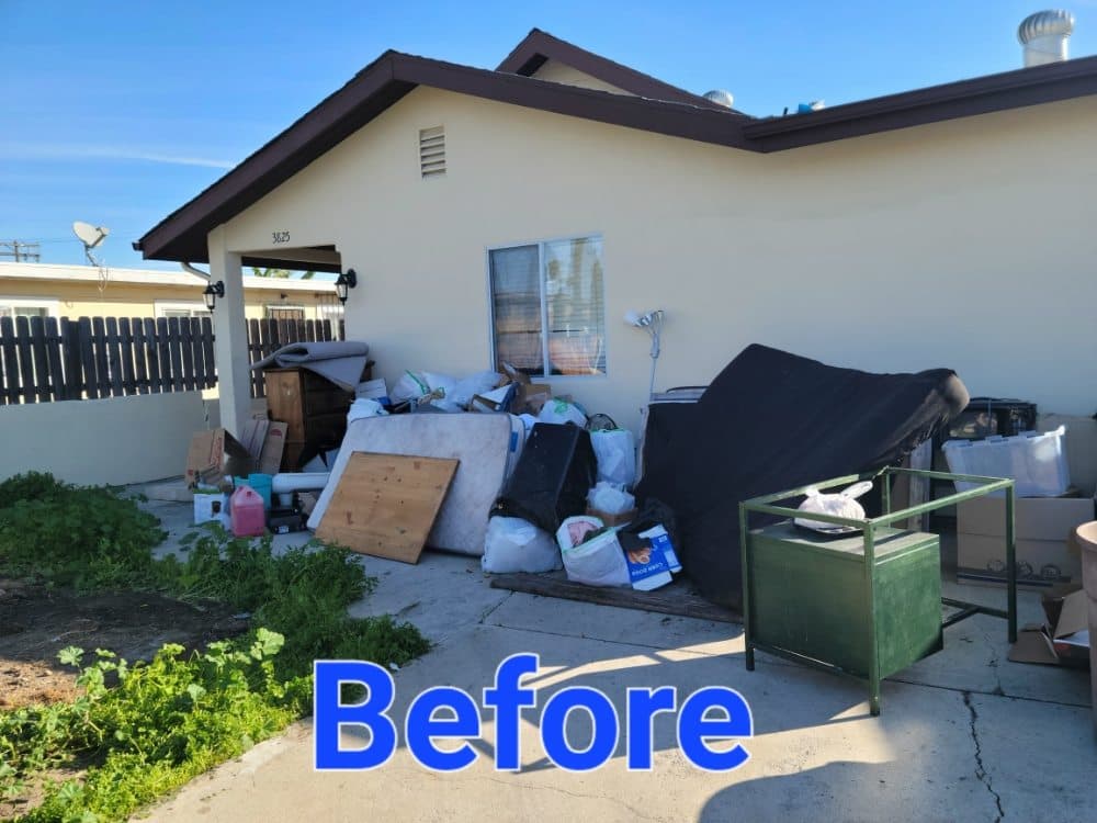 Junk leaning against the side of a house